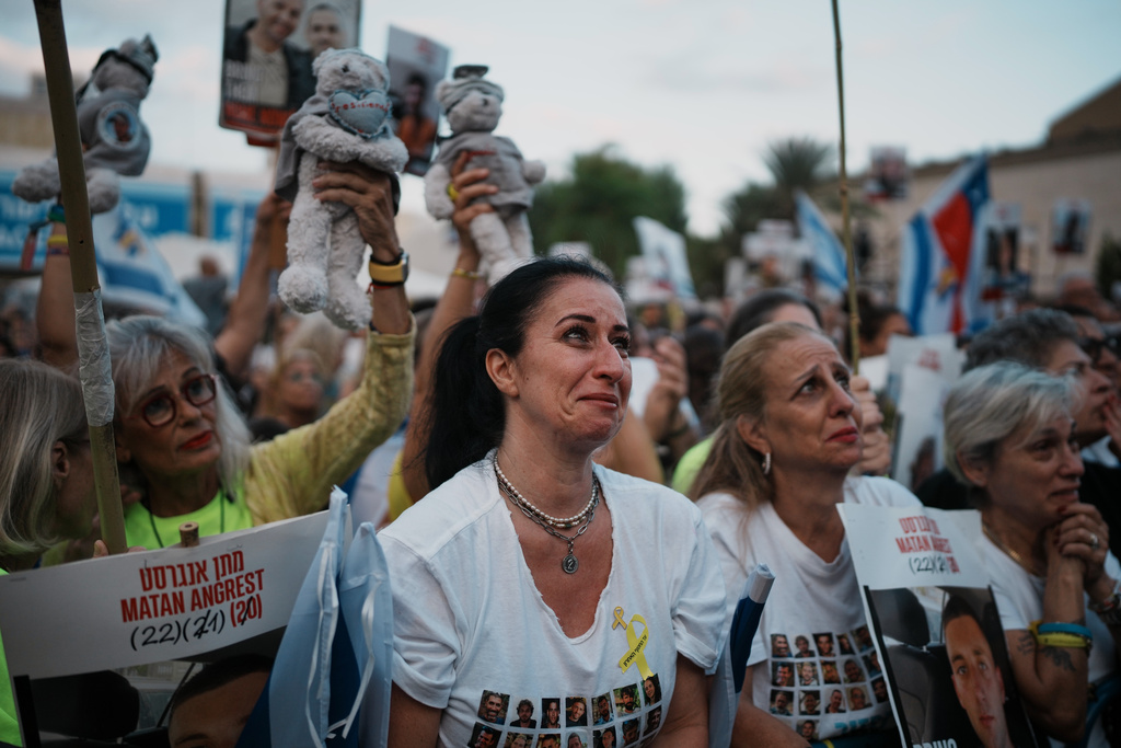 People gather at a plaza known as the hostages square in Tel Aviv, Israel, Monday, Oct. 13, 2025 prior to the release of Israeli hostages held in Gaza. (AP Photo/Emilio Morenatti)