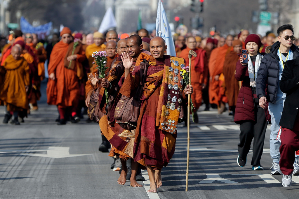 Buddhist monks walk near the Peace Monument on Capitol Hill, during the Walk For Peace, Wednesday, Feb. 11, 2026, in Washington. (AP Photo/Rahmat Gul)