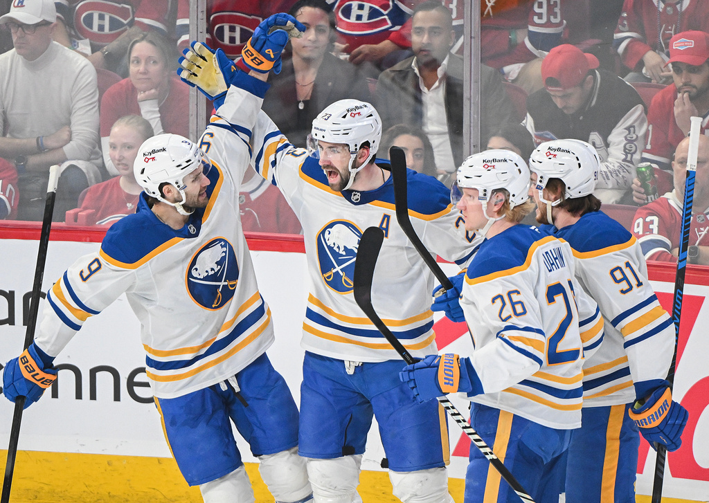 Buffalo Sabres' Mattias Samuelsson (23) celebrates with teammates after scoring against the Montreal Canadiens during the first period in Game 4 of a second-round NHL hockey playoff game in Montreal on Tuesday, May 12, 2026. (Graham Hughes/The Canadian Press via AP)