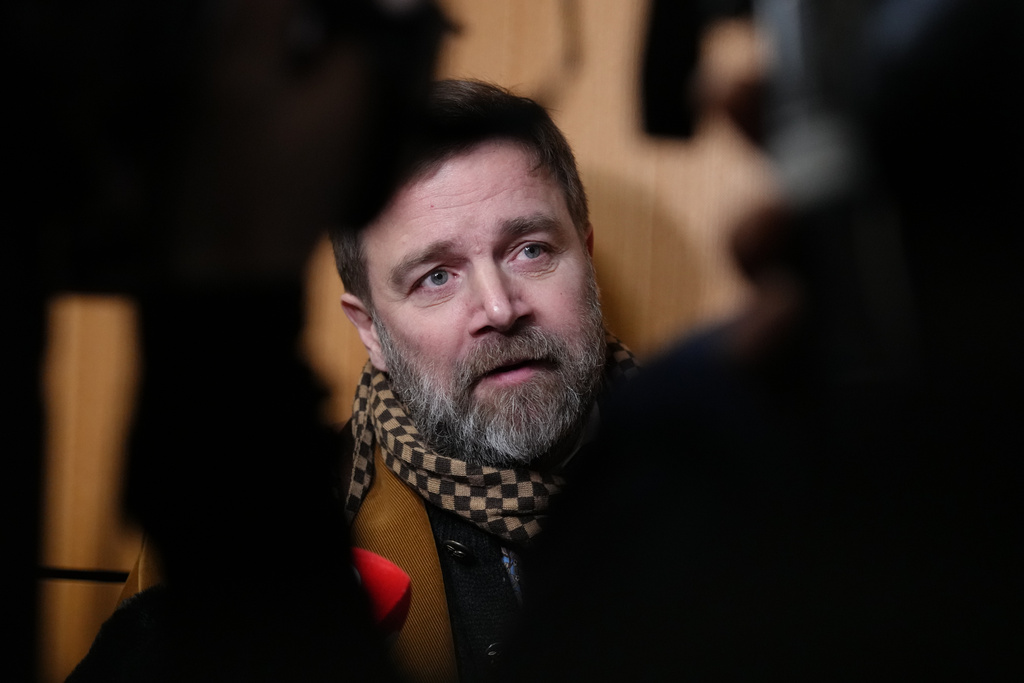 Defendant Bertrand Scholler answers reporters after a Paris court has found 10 people guilty of cyberbullying France's first lady, Brigitte Macron by spreading false online claims about her gender and sexuality, Monday, Jan. 5, 2026 in Paris. (AP Photo/Aurelien Morissard)