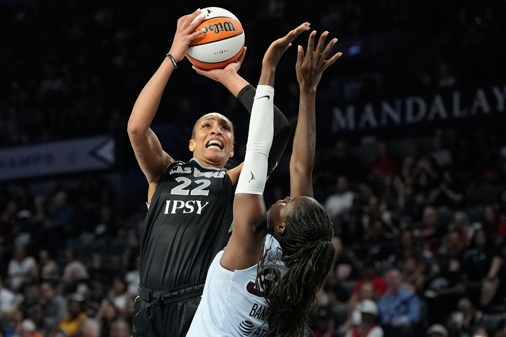 Las Vegas Aces center A'ja Wilson (22) shoots over Toronto Tempo guard Ornella Bankole (33) during the second half of a WNBA basketball game Friday, Aug. 28, 2026, in Las Vegas. (AP Photo/John Locher)