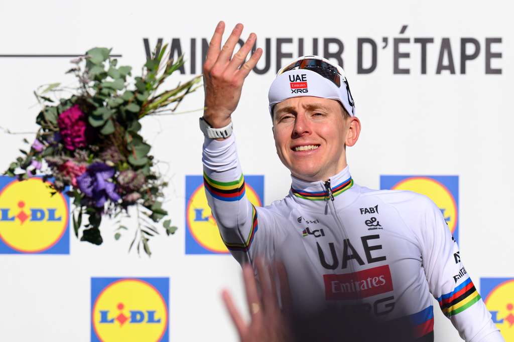 Race's overall leader Tadej Pogacar, from Slovenia, celebrates on the podium after winning the second stage, a 173,1 km race between Rue and Vucherens, of the 79th Tour de Romandie UCI World Tour Cycling race, in Vuillens, Switzerland, Thursday, April 30, 2026. (Laurent Gillieron/Keystone via AP)