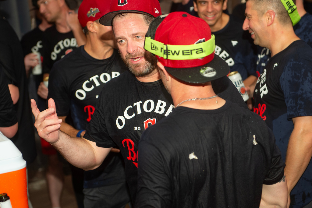 Cleveland Guardians manager Stephen Vogt, center, celebrates with his team after securing an American League playoff spot at the end of a baseball game against the Texas Rangers, Saturday, Sept. 27, 2025, in Cleveland. (AP Photo/Phil Long)