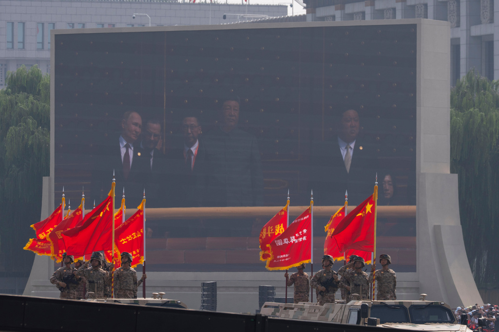 FILE - Russian President Vladimir Putin, Chinese President Xi Jinping and North Korean leader Kim Jong Un are seen on a screen as military personnel take part in a military parade to commemorate the 80th anniversary of Japan's World War II surrender held in front of Tiananmen Gate in Beijing, Wednesday, Sept. 3, 2025. (AP Photo/Ng Han Guan, File)