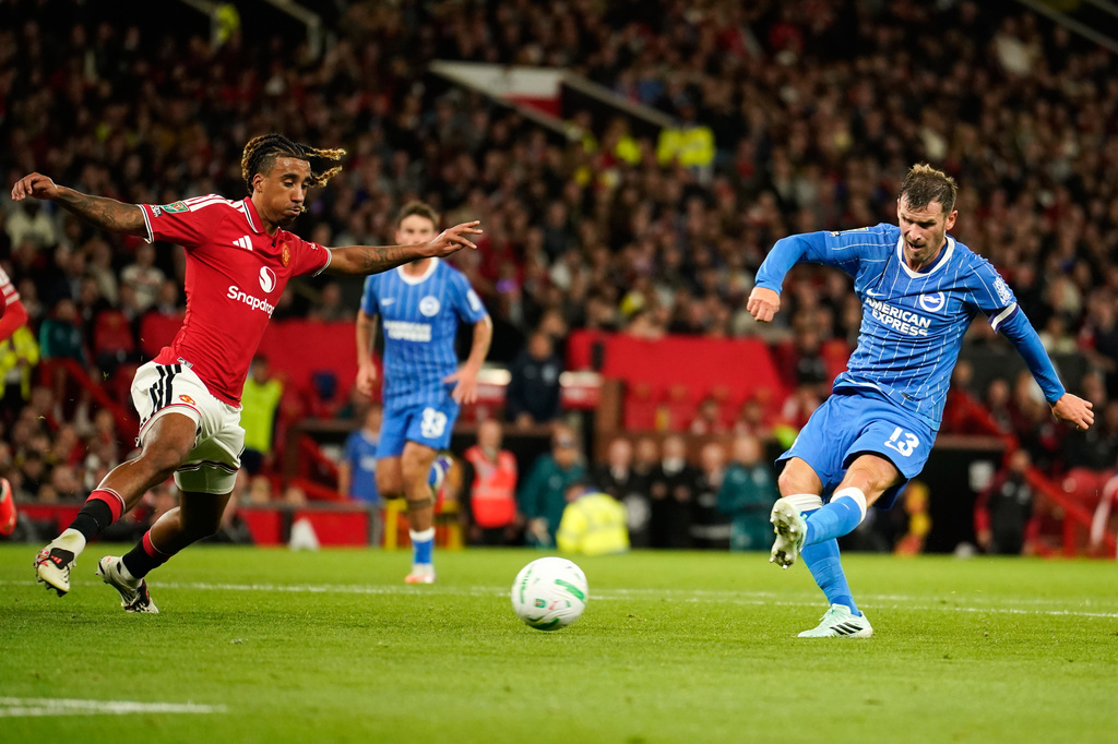 Brighton's Pascal Gross, right, scores his side's second goal during the English League Cup third round soccer match between Manchester United and Brighton and Hove Albion in Manchester, England, Wednesday, Sept. 16, 2026. (AP Photo/Dave Thompson)