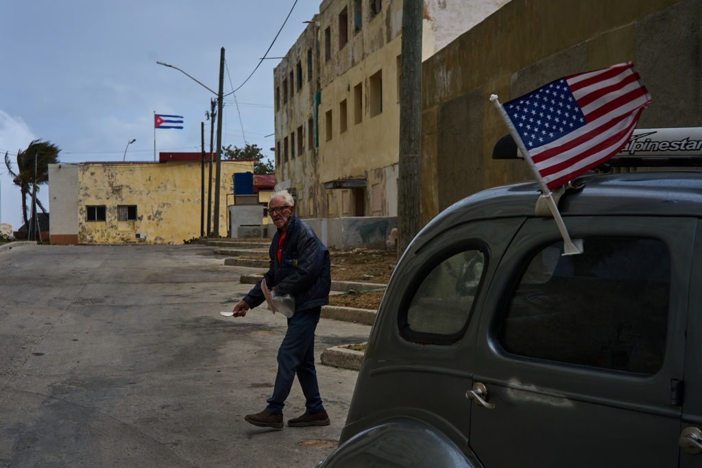 A man walks between American and Cuban flags in Havana, Sunday, Feb. 1, 2026. (AP Photo/Ramon Espinosa)