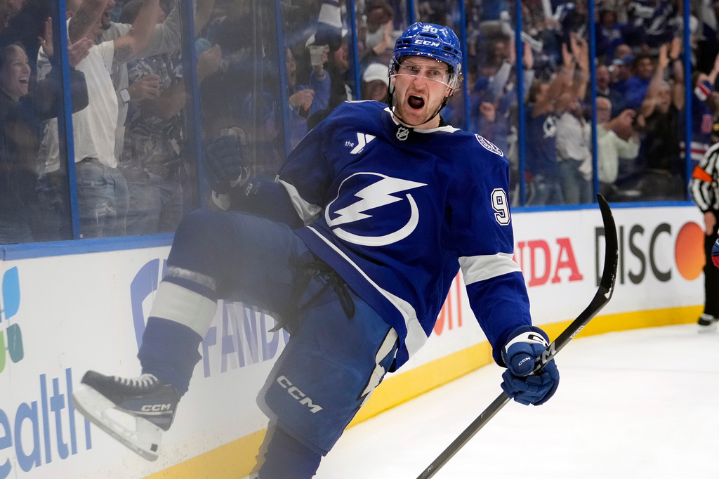 Tampa Bay Lightning defenseman J.J. Moser (90) celebrates after scoring the game-winning goal against the Montréal Canadiens during overtime in Game 2 of an NHL hockey Stanley Cup first-round playoff series, Tuesday, April 21, 2026, in Tampa, Fla. (AP Photo/Chris O'Meara)