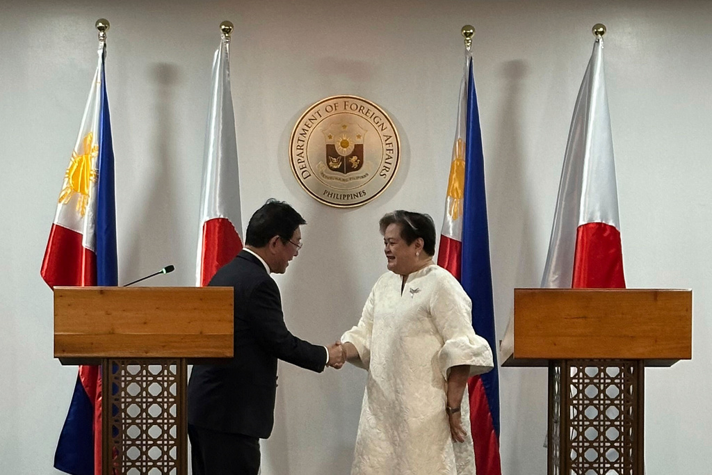 Japanese Foreign Minister Toshimitsu Motegi, left, and Philippine Foreign Secretary Theresa Lazaro shake hands in Manila, Thursday, Jan. 15, 2026. (AP Photo/Joeal Calupitan)