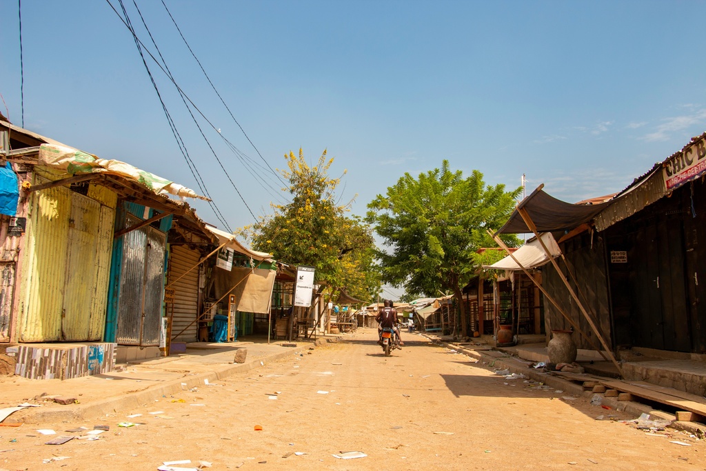 A lone motorcyclist rides the empty streets of Garoua, northern Cameroon, Tuesday, Nov. 4, 2025. (AP Photo/Pascal Welba Yamo )
