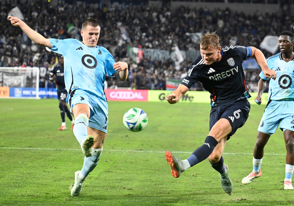 San Diego FC defender Jeppe Tverskov (6) shoots past Minnesota United midfielder Robin Lod (17) during the first half of MLS soccer's Western Conference semifinal Monday, Nov. 24, 2025, in San Diego. (AP Photo/Denis Poroy)