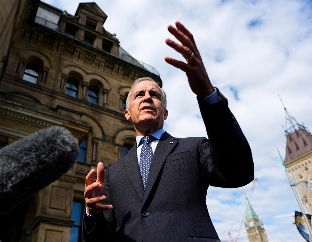 Prime Minister Mark Carney speaks to journalists as he arrives at the Office of the Prime Minister and Privy Council in Ottawa, on Tuesday, Sept. 1, 2026. (Justin Tang/The Canadian Press via AP)