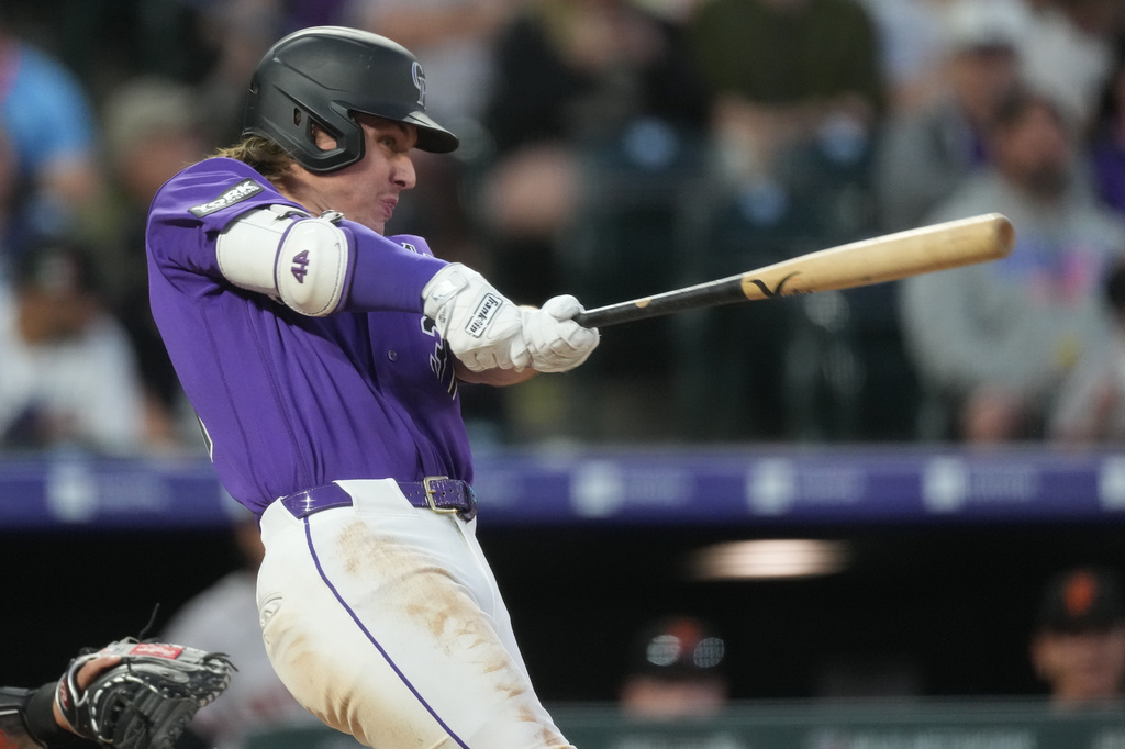 Colorado Rockies' Jake McCarthy connects for a two-run home run off San Francisco Giants starting pitcher Adrian Houser in the fourth inning of a baseball game Saturday, May 30, 2026, in Denver. (AP Photo/David Zalubowski)