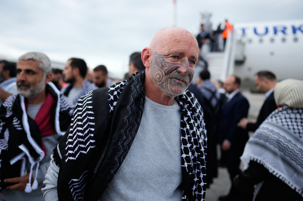 Activists from the Global Sumud Flotilla disembark a plane upon arriving at Istanbul Airport, in Istanbul, Turkey, Thursday, May 21, 2026. (AP Photo/Emrah Gurel)