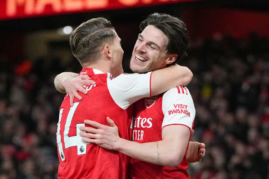 Arsenal's Viktor Gyoekeres and Arsenal's Declan Rice celebrate after Brighton's Georginio Rutter scored an own goal during the English Premier League soccer match between Arsenal and Brighton and Hove Albion in London, Saturday, Dec. 27, 2025. (AP Photo/Kirsty Wigglesworth)