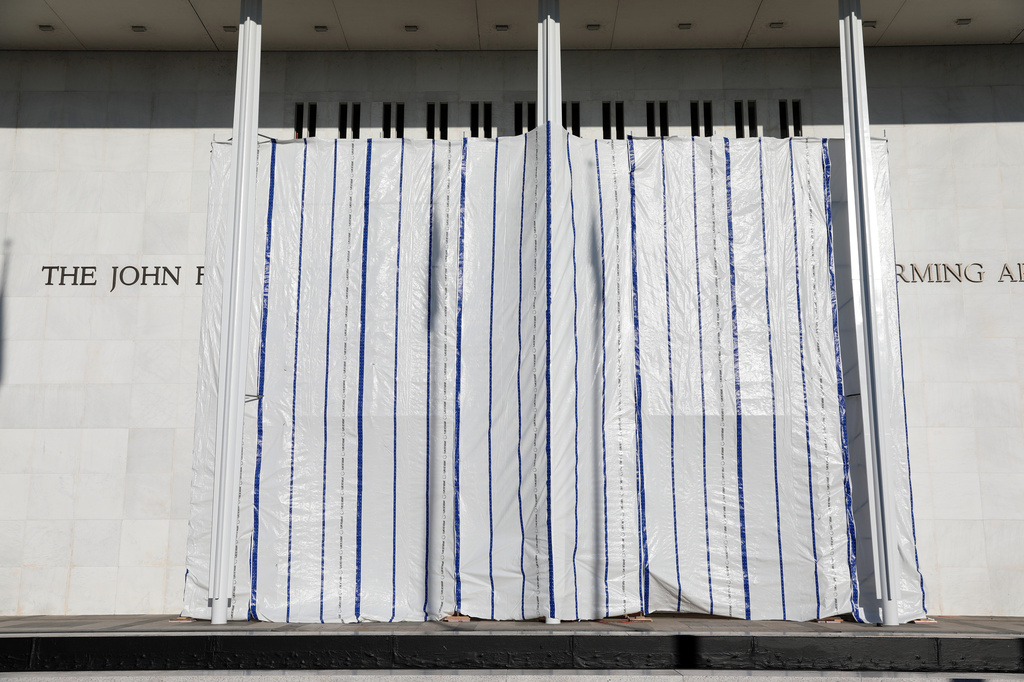 The wall of the John F. Kennedy Center for the Performing Arts is covered in tarp after President Donald Trump's name was removed, in Washington, Saturday, June 13, 2026. (AP Photo/Rahmat Gul)