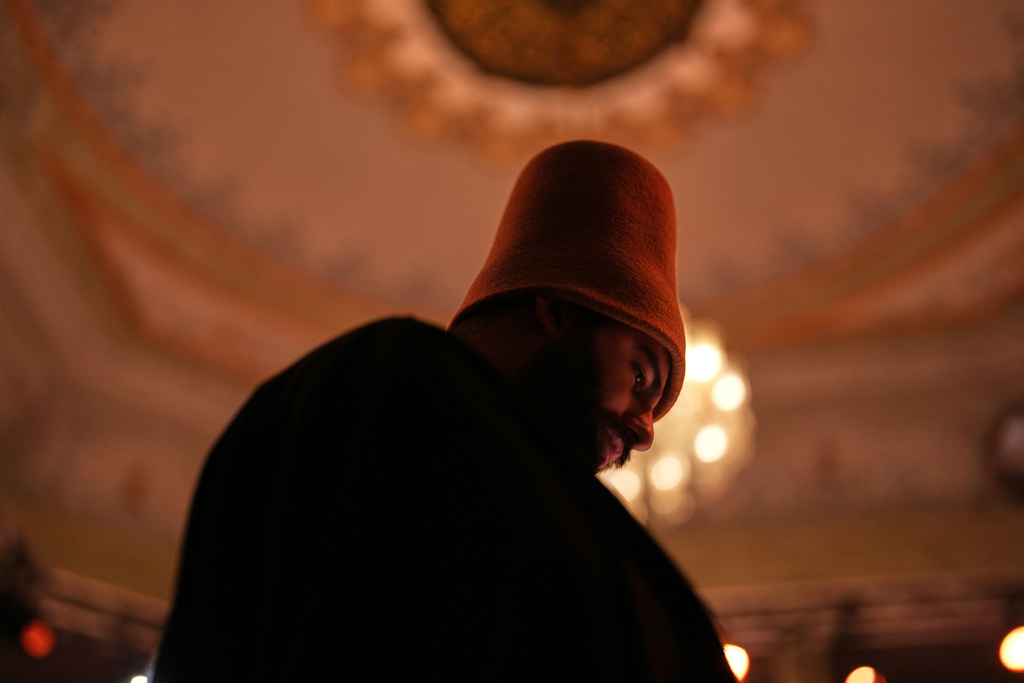 A whirling dervish of the Mevlevi order performs during a Sheb-i Arus ceremony at Kasimpasa Mevlevihane in Istanbul, Turkey, Thursday, Dec. 11, 2025, to commemorate the death of 13th century Islamic scholar, poet and Sufi mystic Jalaladdin Rumi. (AP Photo/Francisco Seco)