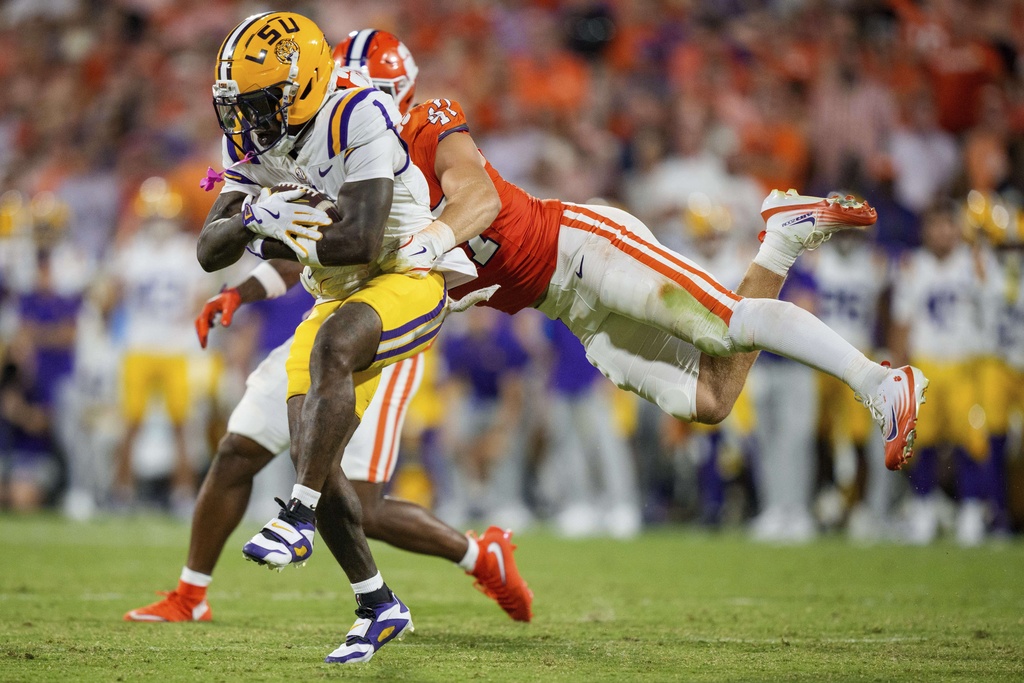Clemson linebacker Sammy Brown (47) tackles LSU wide receiver Aaron Anderson (1) in the first half of an NCAA college football game, Saturday, Aug. 30, 2025, in Clemson, S.C. (AP Photo/Jacob Kupferman)