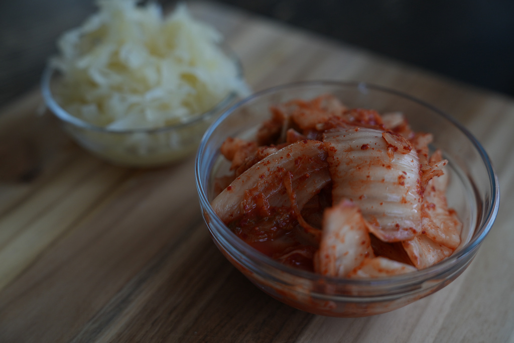 Kimchi and sauerkraut are displayed on a kitchen table in New York on July 10, 2026. (AP Photo/Mary Conlon)