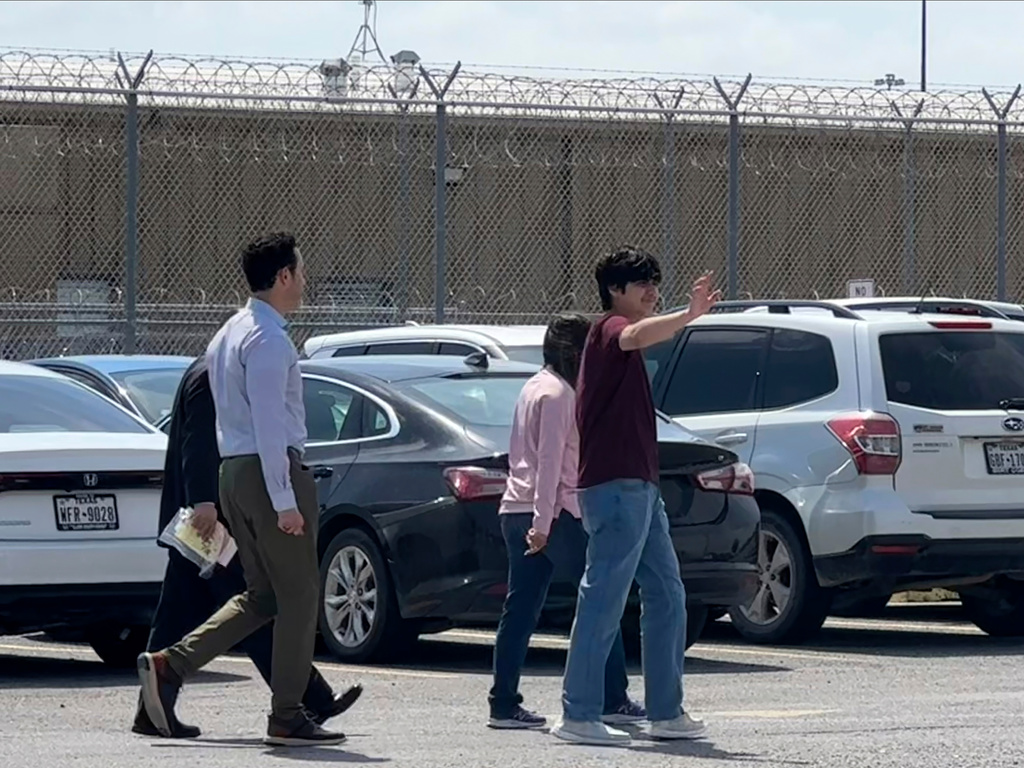 Antonio Gamez Cuéllar, 18, walks out of the El Valle Detention Facility in Raymondville, Texas on Monday, March 9, 2026 escorted by his attorneys, Efrén C. Olivares and Carlos M. Garcia, and Republican congresswoman Monica de la Cruz of District 15. (AP Photo/Valerie Gonzalez)