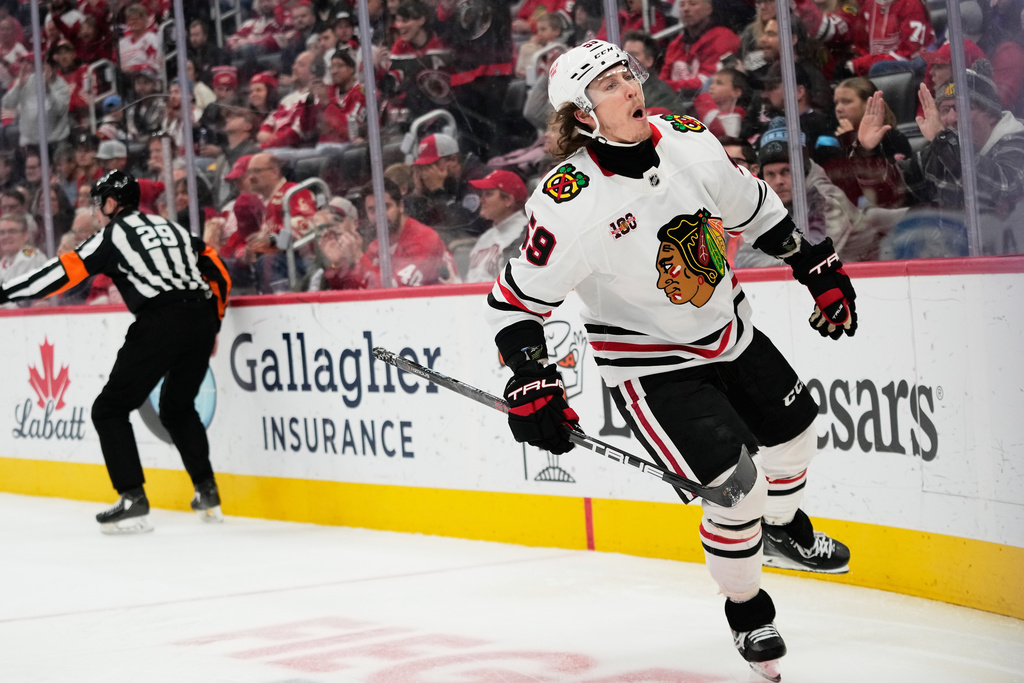 Chicago Blackhawks left wing Tyler Bertuzzi, right, celebrates after scoring during the third period of an NHL hockey game against the Detroit Red Wings, Sunday, Nov. 9, 2025, in Detroit. (AP Photo/Ryan Sun)