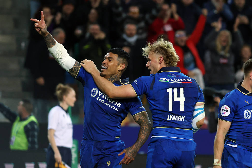 Italy's Monty Ioane, left, celebrates after scoring a try during the rugby union match between Italy and Australia in Udine, Italy, Saturday, Nov. 8, 2025. (Andrea Bressanutti/LaPresse via AP)