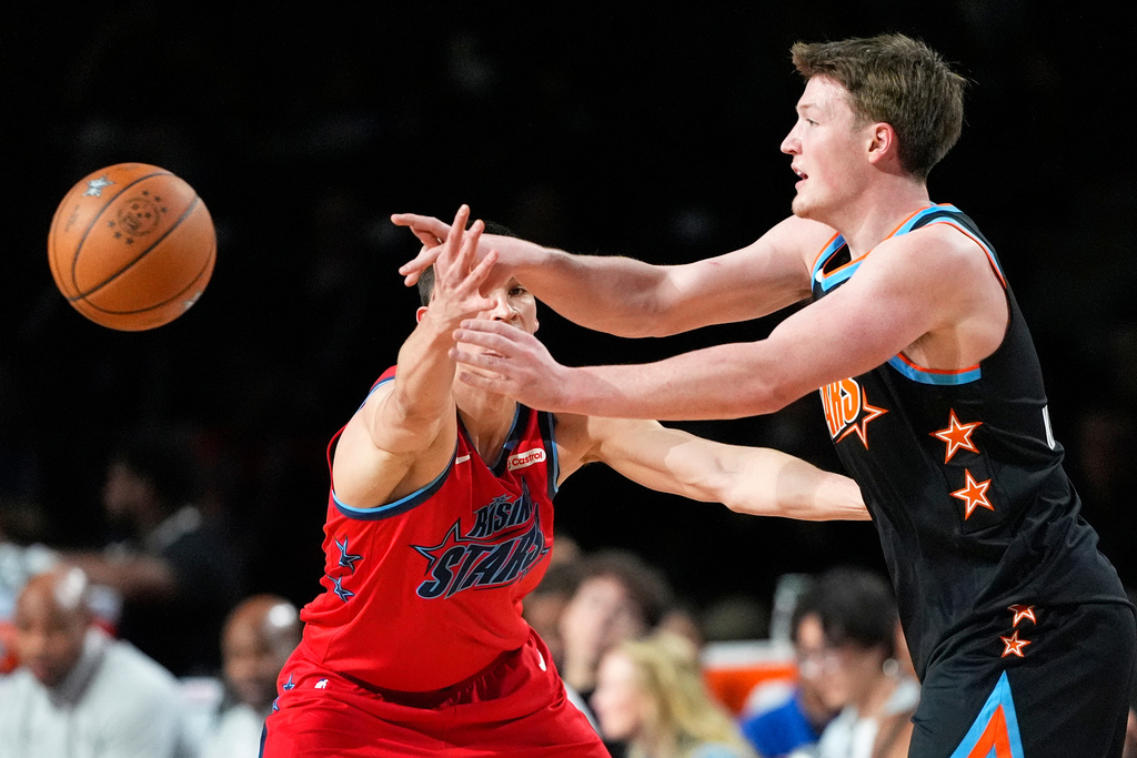 Team T-Mac guard Kon Knueppel (7) of the Charlotte Hornets, right, passes while under pressure from Team Vince guard Egor Demin (8) of the Brooklyn Nets during an NBA basketball's Rising Stars event Friday, Feb. 13, 2026, in Inglewood, Calif. (AP Photo/Mark J. Terrill)