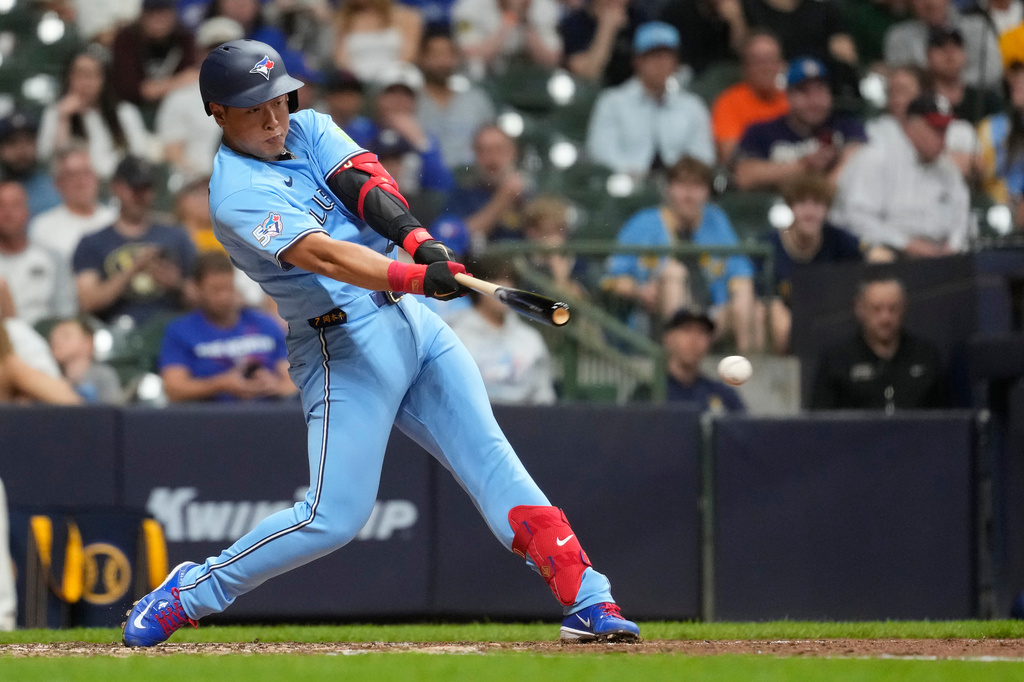 Toronto Blue Jays' Kazuma Okamoto hits an infield single during the seventh inning of a baseball game against the Milwaukee Brewers, Tuesday, April 14, 2026, in Milwaukee. (AP Photo/Aaron Gash)