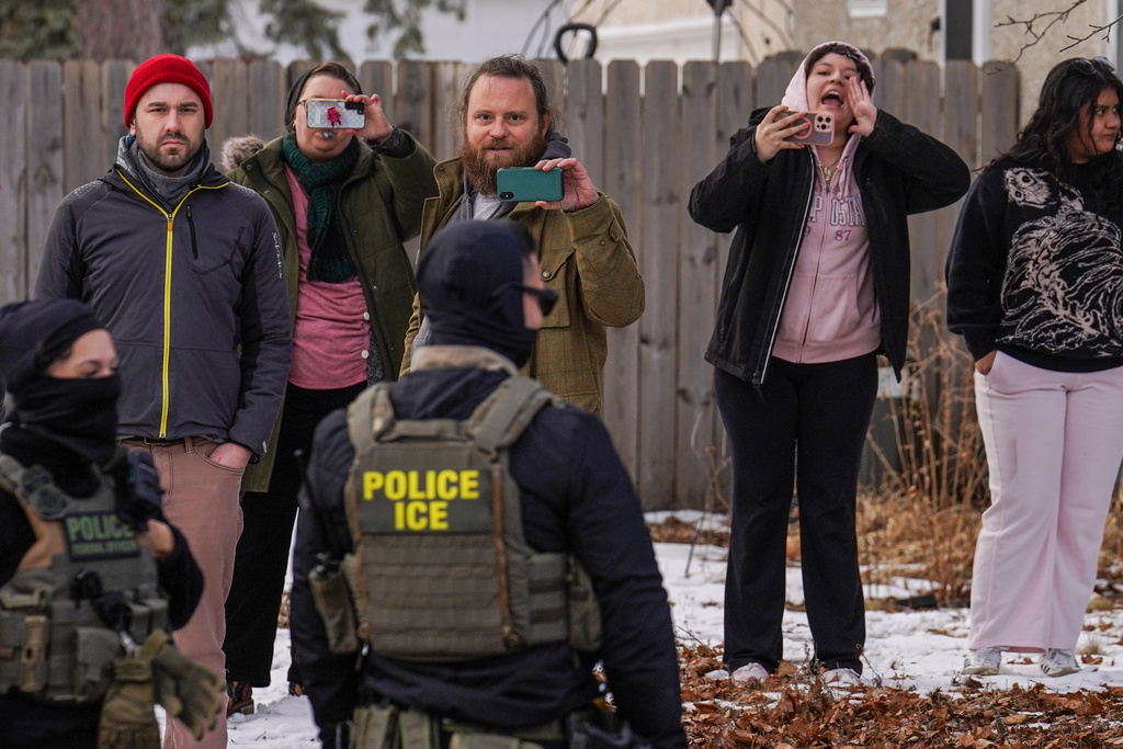 FILE - Observers film while federal agents conduct immigration enforcement operations Thursday, Feb. 5, 2026, in Minneapolis. (AP Photo/Ryan Murphy, File)