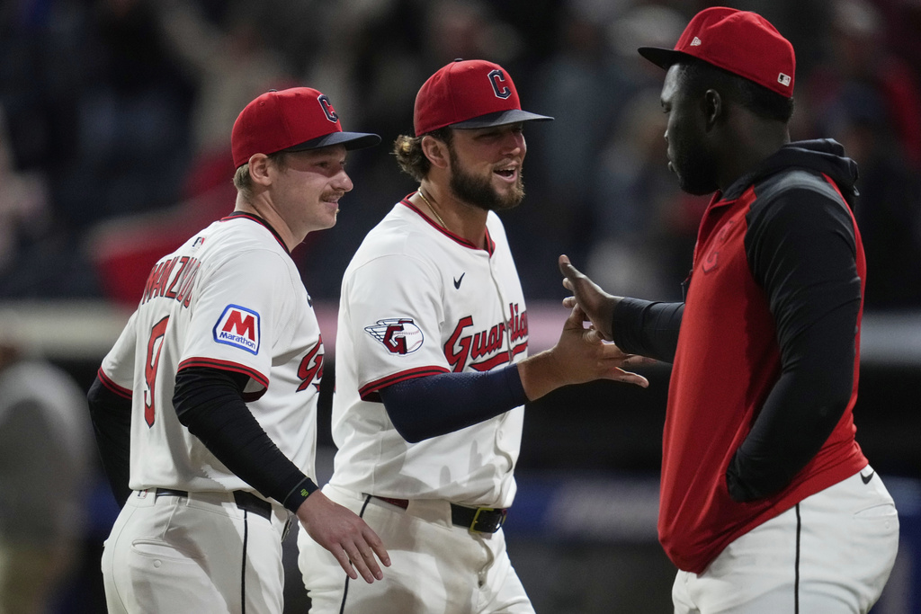 Cleveland Guardians starting pitcher Slade Cecconi, center, celebrates with teammates after the Guardians defeated the Kansas City Royals in a baseball game in Cleveland, Monday, Sept. 8, 2025. (AP Photo/Sue Ogrocki)