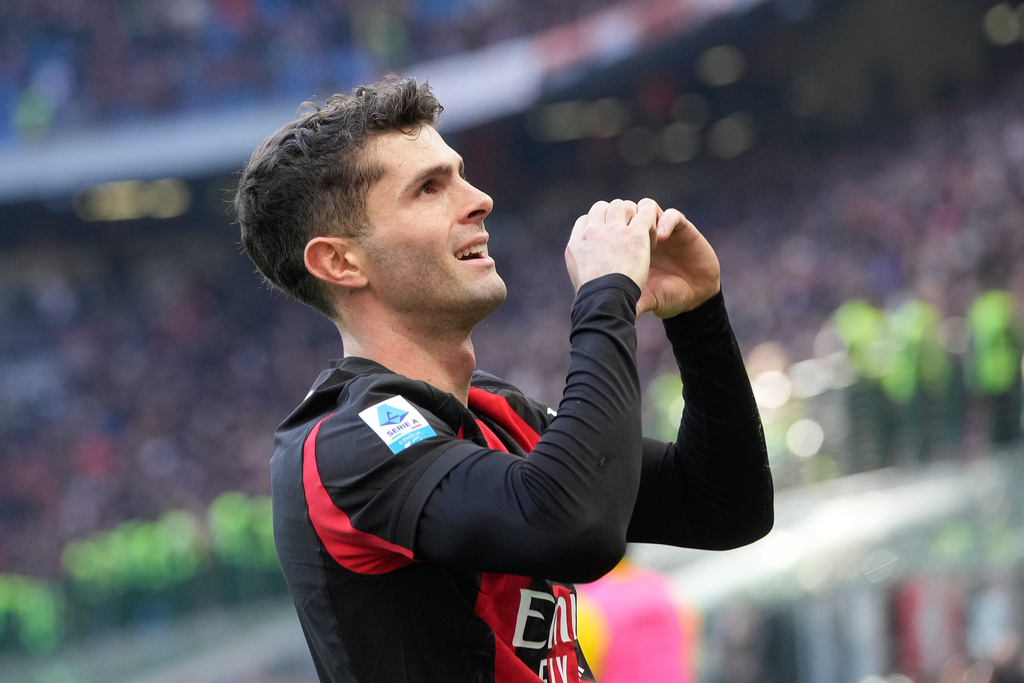 AC Milan's Christian Pulisic celebrates after scoring his side's first goal during a Serie A soccer match between AC Milan and Hellas Verona, in Milan, Italy, Sunday, Dec. 28, 2025. (AP Photo/Luca Bruno)