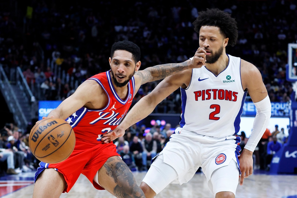 Philadelphia 76ers guard Cameron Payne (20) drives against Detroit Pistons guard Cade Cunningham (2) during the first half of an NBA basketball game Thursday, March 12, 2026, in Detroit. (AP Photo/Duane Burleson)