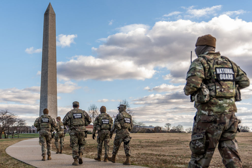 FILE - National Guardsmen patrol in front of the Washington Monument on the National Mall, Friday, Nov. 28, 2025, in Washington. (AP Photo/Julia Demaree Nikhinson, File)