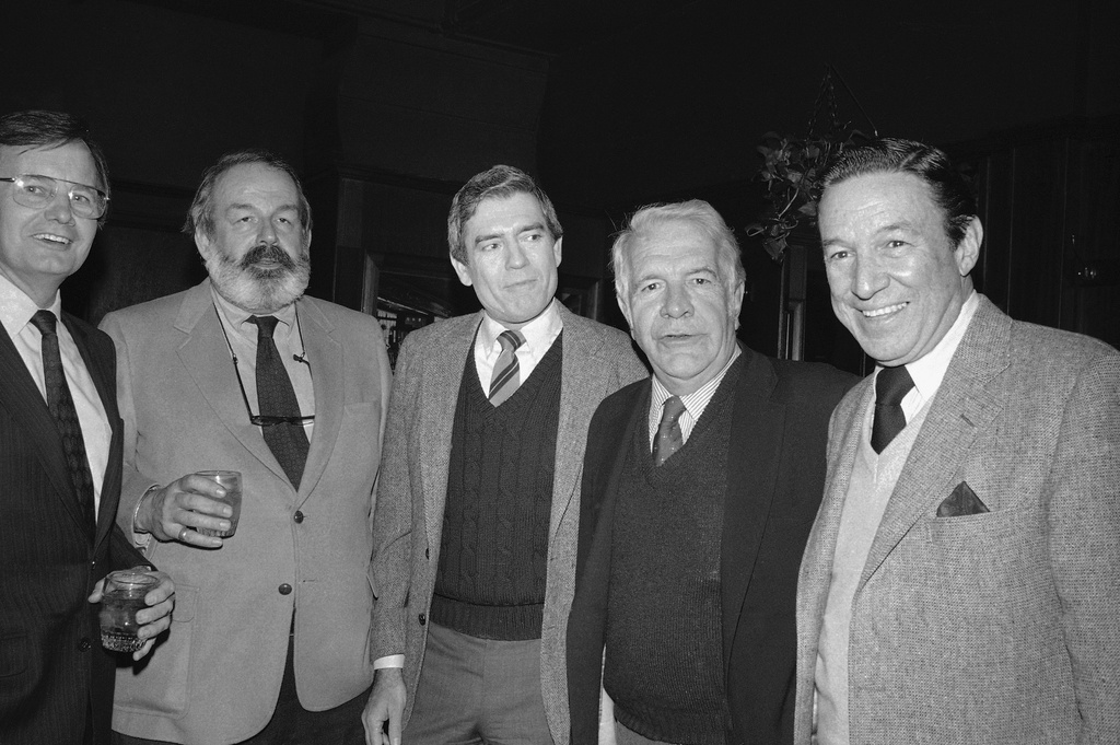 FILE - Dan Rather, center, joined by Harry Reasoner, second from right, and Mike Wallace, right, celebrates his first anniversary as anchorman and managing editor of the CBS Evening News, at a restaurant in New York, March 9, 1982. (AP Photo/Nancy Kaye, File)
