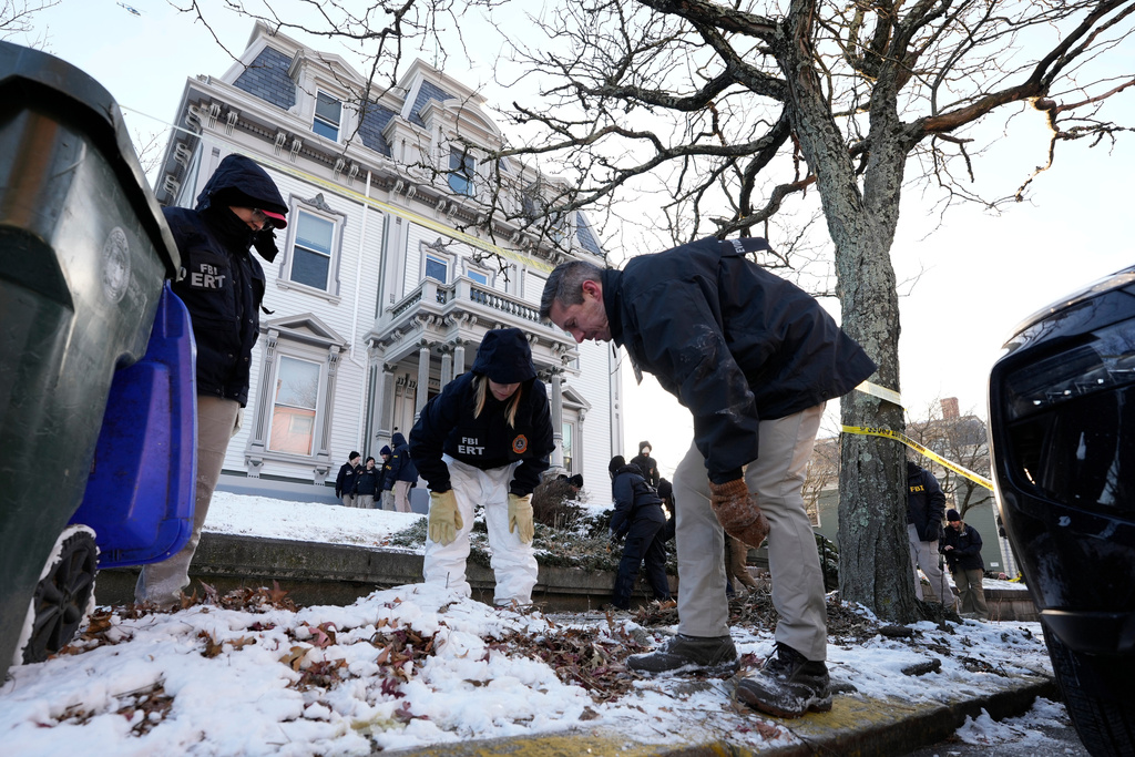 Members of the FBI Evidence Response Team search for evidence near the campus of Brown University, Monday, Dec. 15, 2025, in Providence, R.I. (AP Photo/Robert F. Bukaty)