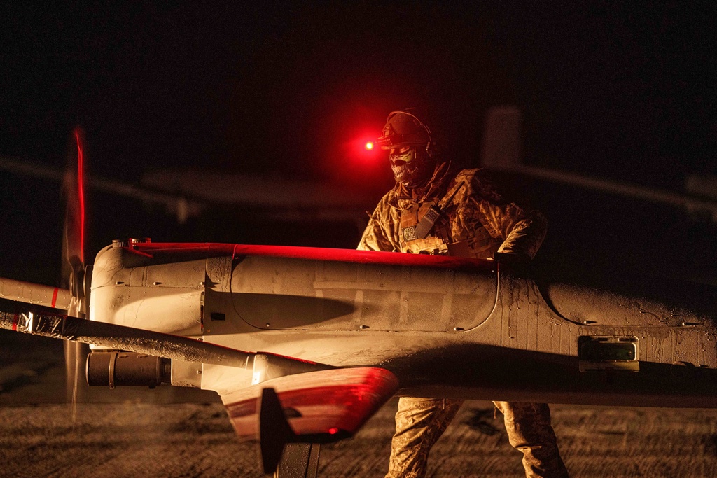 A Ukrainian serviceman of the 14th Separate Unmanned Aerial Systems Regiment prepares a long-range drone An-196 Liutyi before takeoff in undisclosed location, Ukraine, Tuesday, Oct. 14, 2025. (AP Photo/Evgeniy Maloletka)