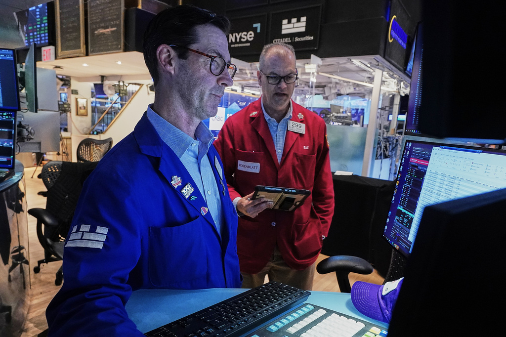 Specialist John McNierney, left, and trader William Lawrence work on the floor of the New York Stock Exchange, Wednesday, June 3, 2026. (AP Photo/Richard Drew)