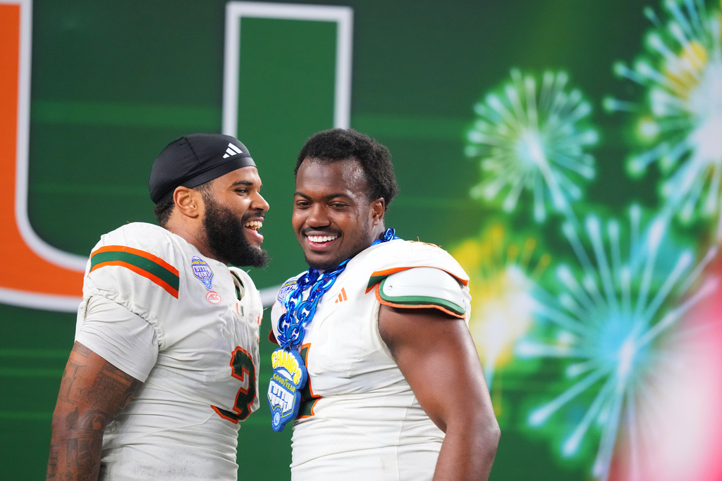 Miami defensive lineman Akheem Mesidor, left, and defensive lineman Rueben Bain Jr. react following the Cotton Bowl College Football Playoff quarterfinal game against Ohio State Wednesday, Dec. 31, 2025, in Arlington, Texas. (AP Photo/Julio Cortez)