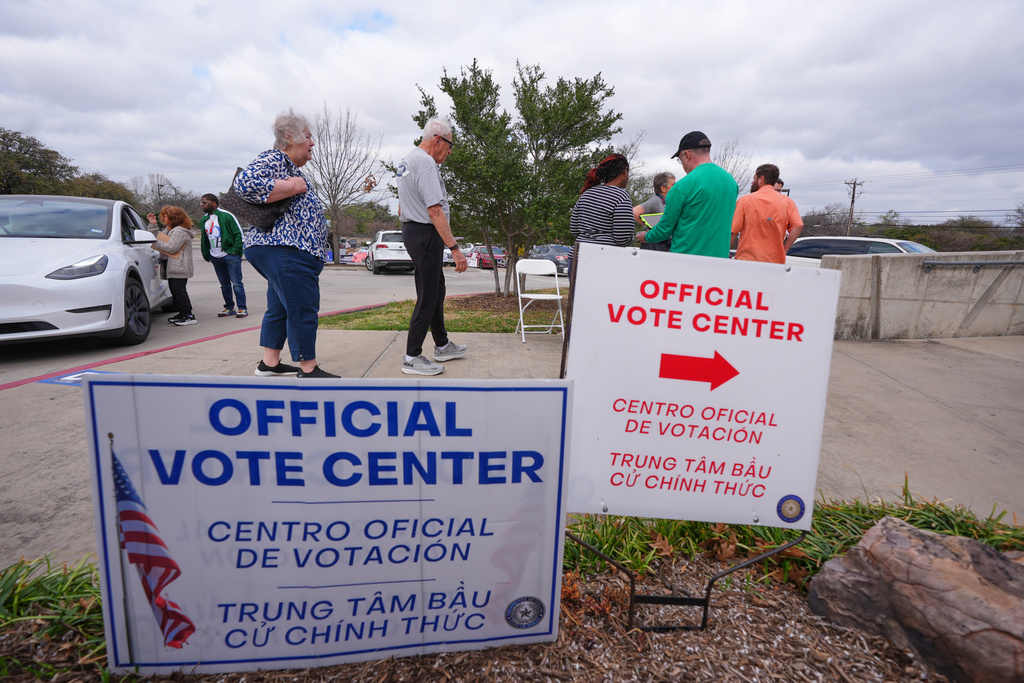 Primary voters arrive to cast ballots at an official vote center in Dallas, Tuesday, March 3, 2026. (AP Photo/LM Otero)