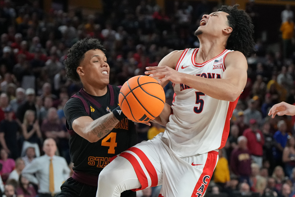 Arizona State guard Bryce Ford (4) knocks the ball away from Arizona guard Brayden Burries during the first half of an NCAA college basketball game, Saturday, Jan. 31, 2026, in Tempe, Ariz. (AP Photo/Rick Scuteri)