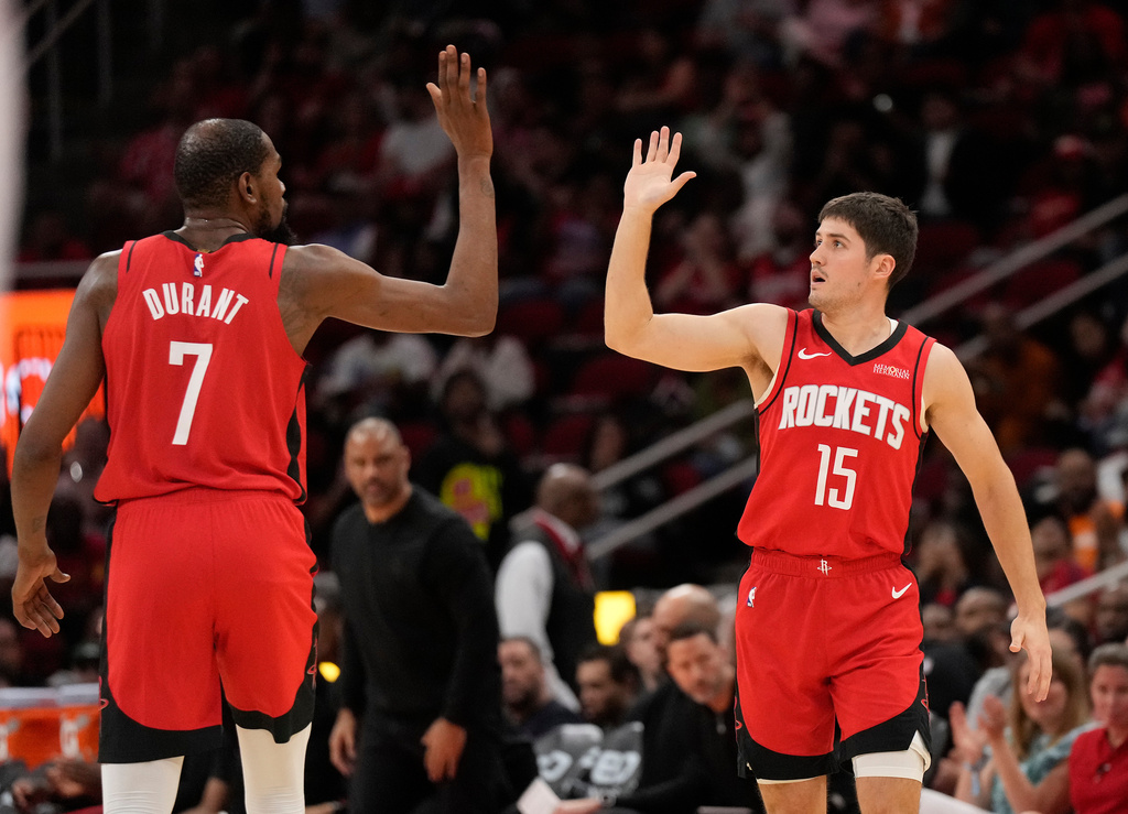 Houston Rockets' Kevin Durant (7) high-fives Reed Sheppard (15) after Sheppard's 3-point basket during the first half of an NBA basketball game against the Utah Jazz, Friday, April 3, 2026, in Houston. (AP Photo/Karen Warren)