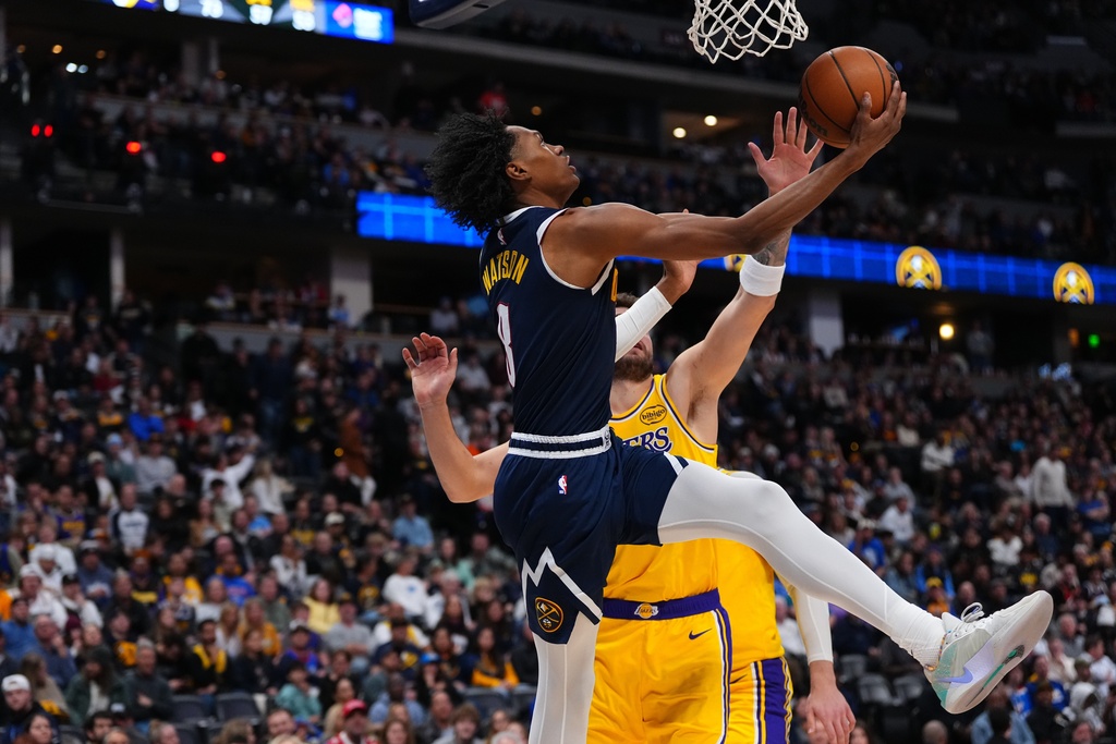 Denver Nuggets guard Peyton Watson (8) goes up for a shot against Los Angeles Lakers forward/guard Luka Dončić (77). during the second half of an NBA basketball game Tuesday, Jan. 20, 2026, in Denver. (AP Photo/Jack Dempsey)