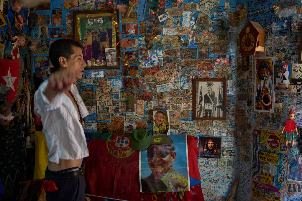 A souvenir shop worker gestures next to images of Raul Castro, Che Guevara and Jose Marti in Havana, Tuesday, June 2, 2026. (AP Photo/Ramon Espinosa)