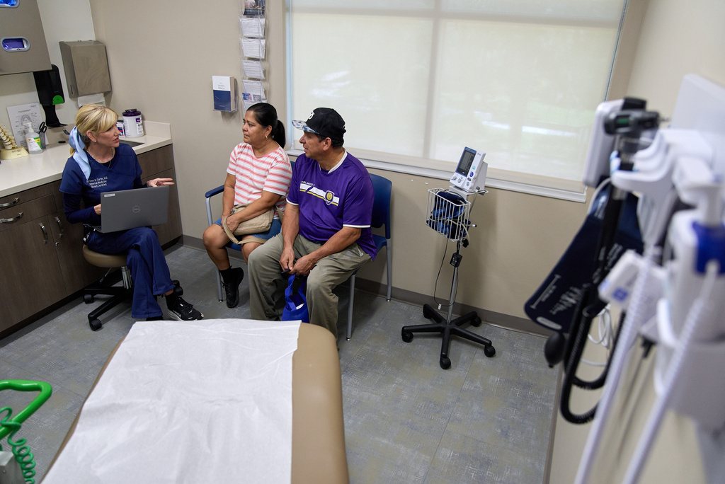 Doctor Kirsten Carter, attends a chronic care appointment for Ana Bautista, and Cesar Granda, of Orlando, Fla., during an appointment at Grace Medical Home in Orlando, Wednesday, Aug. 12, 2026. (AP Photo/Jacquelyn Martin)