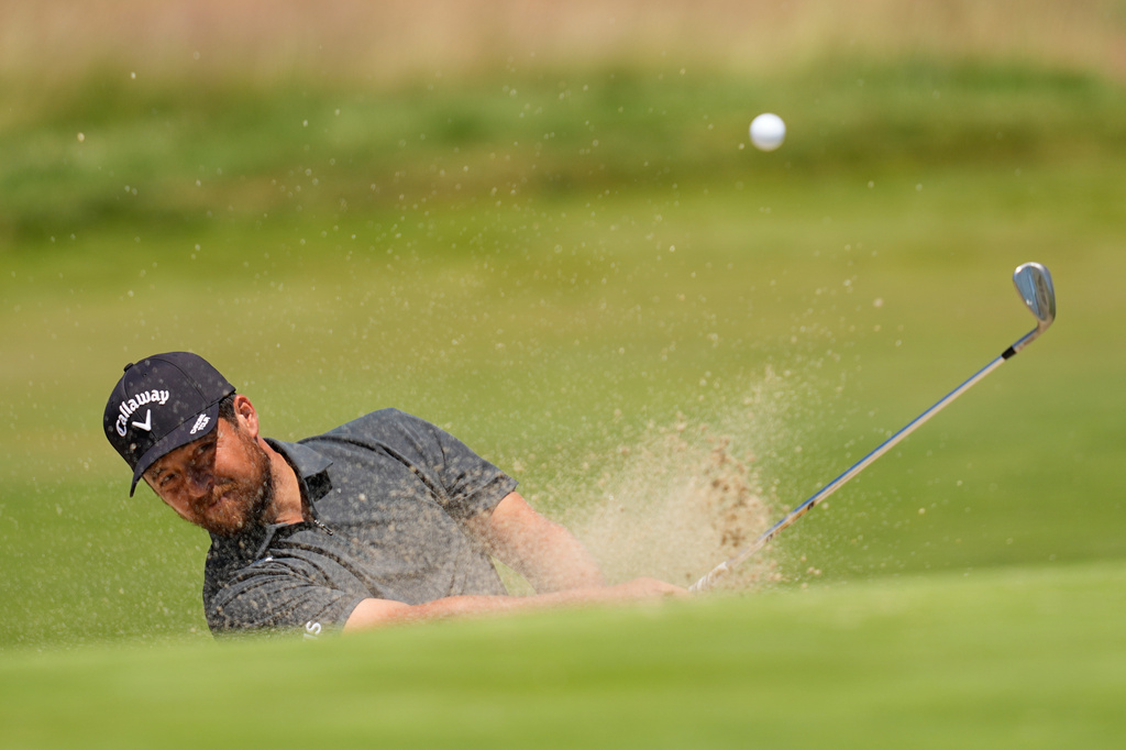 Xander Schauffele hits from the bunker on the fourth hole during a practice round for the U.S. Open golf tournament at Shinnecock Hills Golf Club in Southampton, N.Y., Wednesday, June 17, 2026.(AP Photo/David J. Phillip)