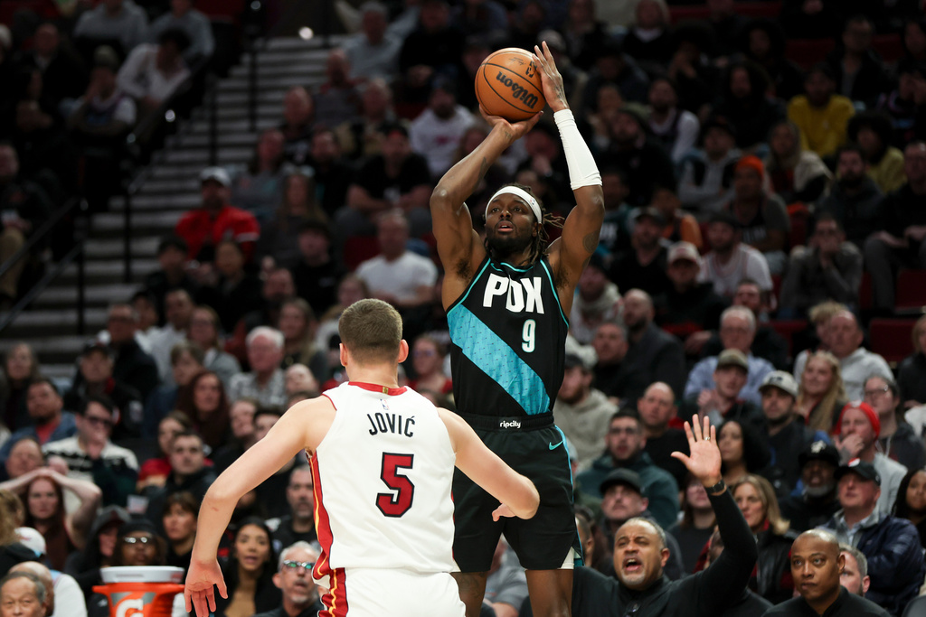 Portland Trail Blazers forward Jerami Grant (9) shoots over Miami Heat forward Nikola Jovic (5) during the second half of an NBA basketball game Thursday, Jan. 22, 2026, in Portland, Ore. (AP Photo/Amanda Loman)