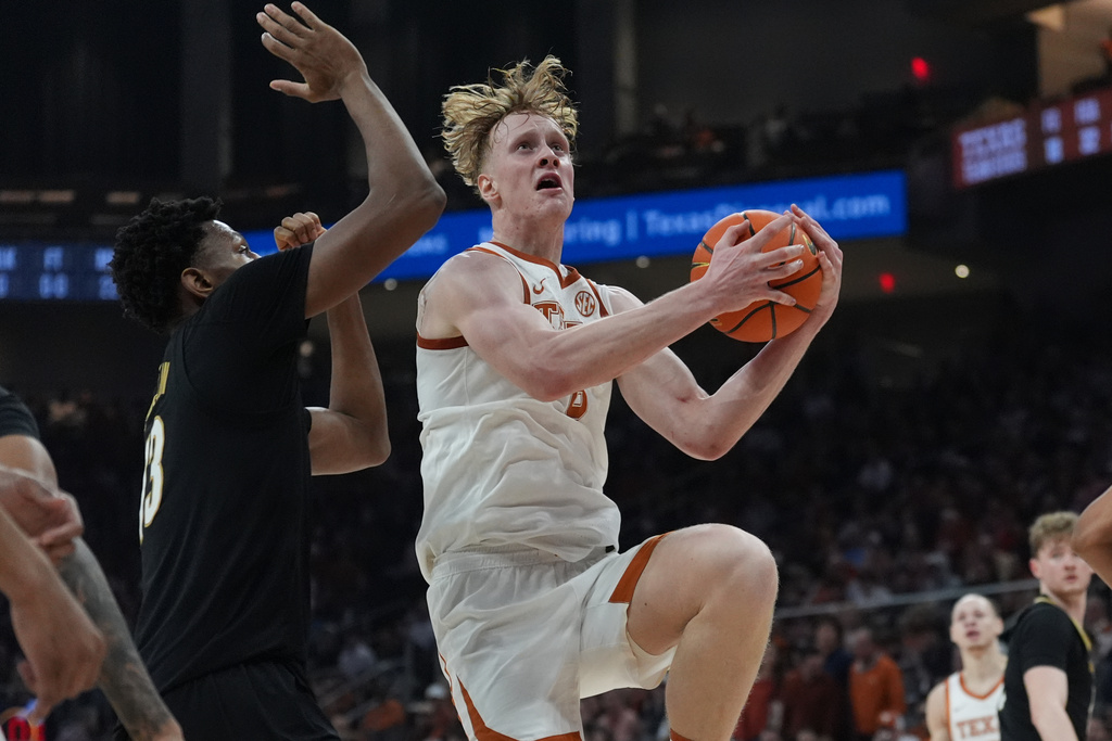 Texas center Matas Vokietaitis (8) drives to the basket against Vanderbilt center Jalen Washington (13) during the second half of an NCAA college basketball game in Austin, Texas, Wednesday, Jan. 14, 2026. (AP Photo/Eric Gay)