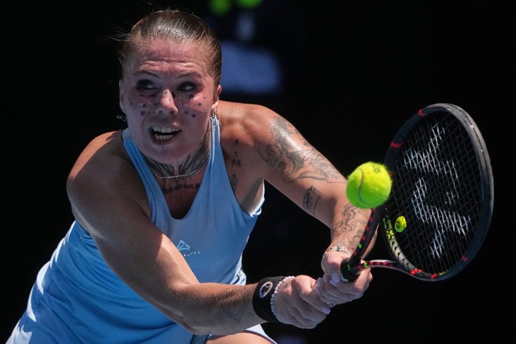 Oleksandra Oliynykova of Ukraine plays a backhand return to Madison Keys of the U.S. during their first round match at the Australian Open tennis championship in Melbourne, Australia, Tuesday, Jan. 20, 2026. (AP Photo/Asanka Brendon Ratnayake)