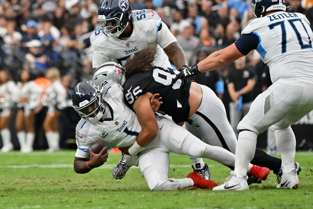 Las Vegas Raiders defensive tackle Leki Fotu (95) sacks Tennessee Titans quarterback Cam Ward (1) during the second half of an NFL football game, Sunday, Oct. 12, 2025, in Las Vegas. (AP Photo/David Becker)