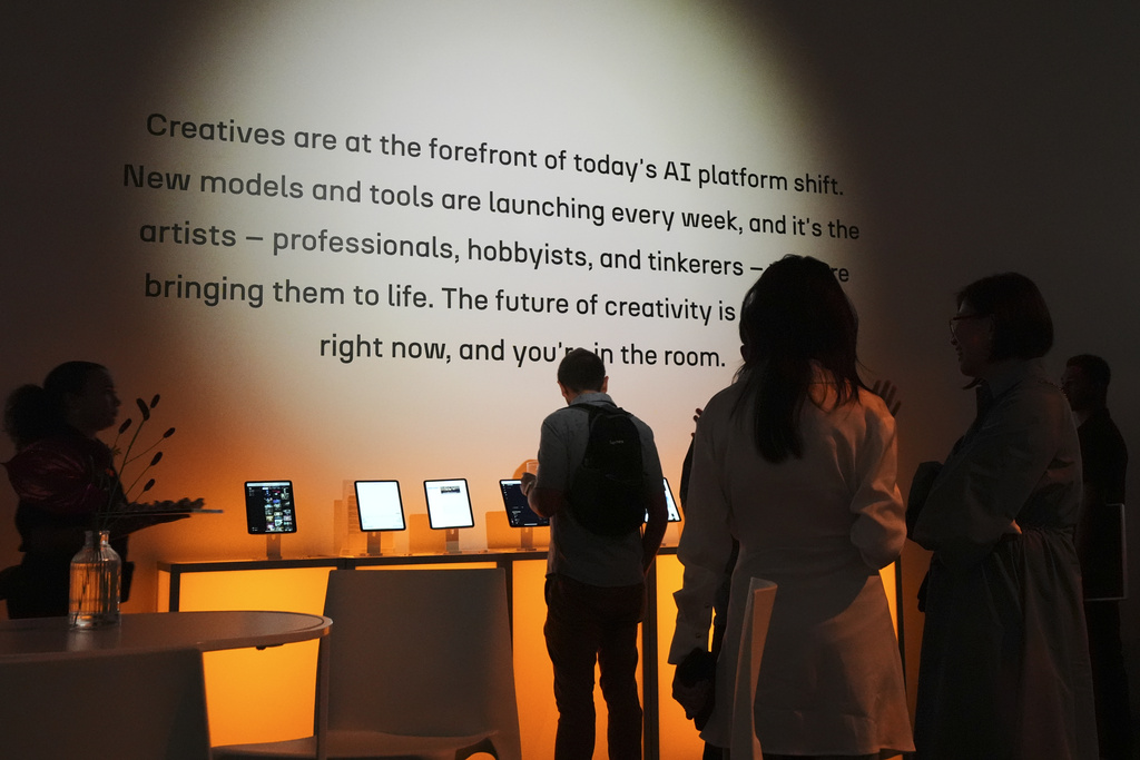People gather at the a16z AI Creative Gallery, Thursday, Sept. 18, 2025, in New York. (AP Photo/Frank Franklin II)