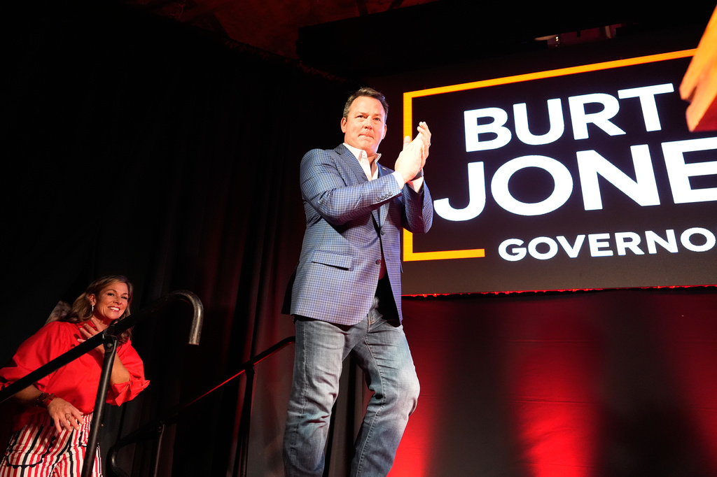 Georgia gubernatorial candidate Burt Jones, is followed on stage by his wife Jan during a primary election night watch party, Tuesday, May 19, 2026, in Jackson, Ga. (AP Photo/Mike Stewart)